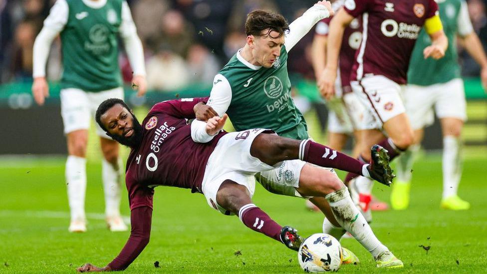 Hearts' Beni Beningime challenges Hibs' Josh Campbell