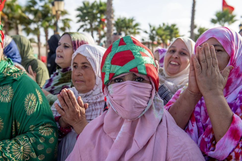 Women in colourful headdresses clap and celebrate in Laayoune - Thursday 6 November 2025.