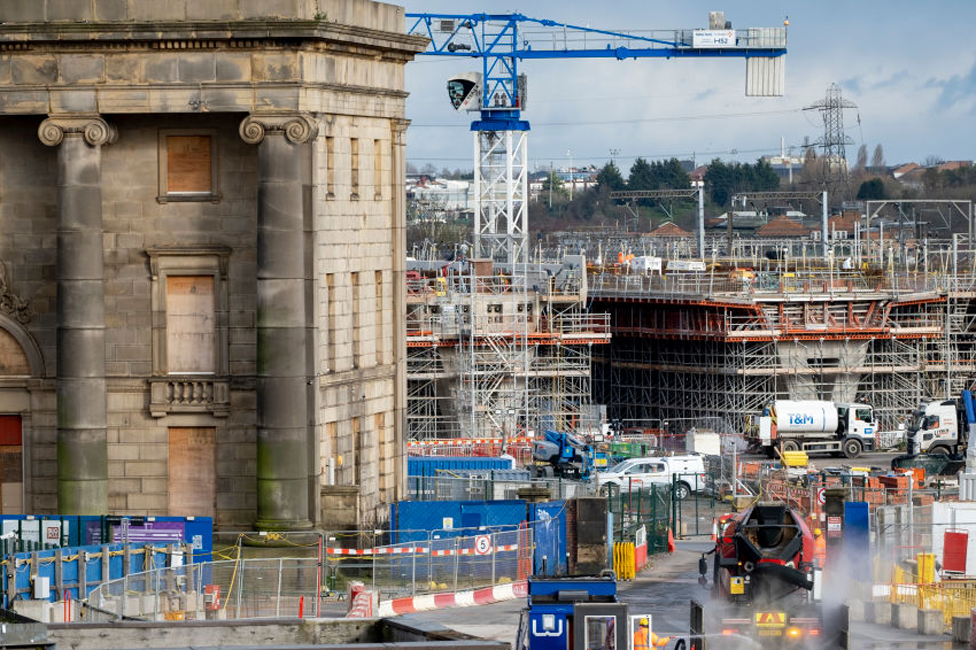 The HS2 rail construction site at the Curzon Street Hub in Birmingham city centre, showing cranes and building work near the old station building.