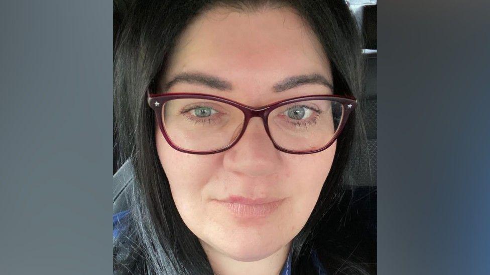 Selfie of Emma McLeod who had dark hair and wears glasses.