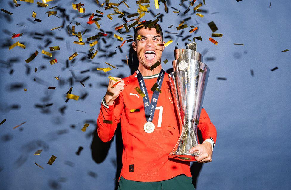 Cristiano Ronaldo poses for a photo with the UEFA Nations League trophy after the UEFA Nations League Final between Spain and Portugal. Photo by Sebastian Widmann