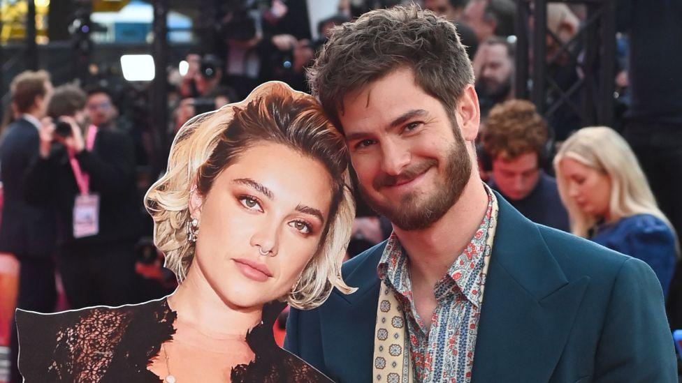 Andrew Garfield (R) poses with a cardboard cutout of Florence Pugh at the Headline Gala screening of 