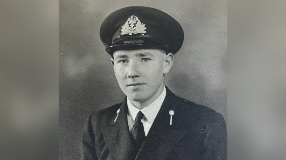 A Second World War portrait of Douglas Parish, he is wearing a naval uniform and a hat