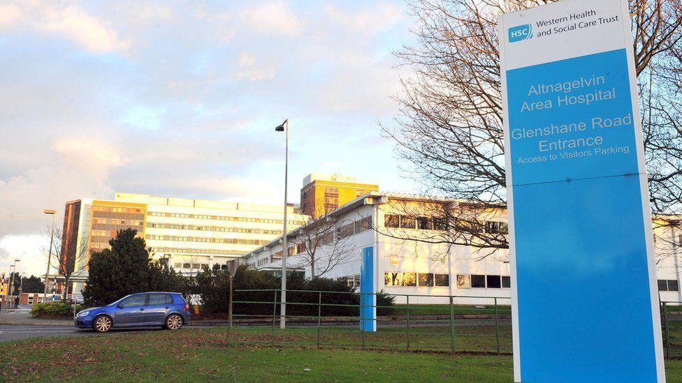 A general view of Altnagelvin Hospital - in the foreground is a blue sign reading "Altnagelvin Hospital Glenshane Road Entrance"