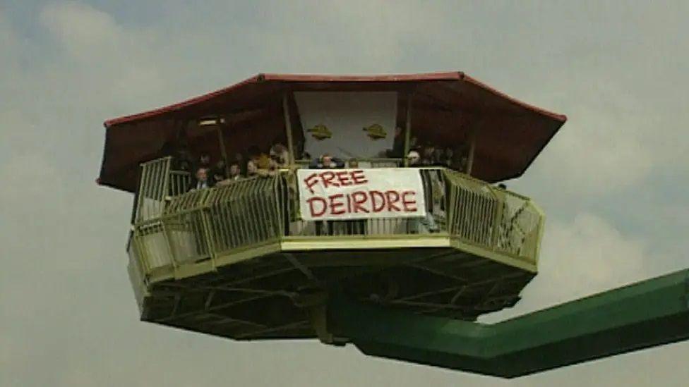 A banner saying Free Deirdre unfurled on an observation tower