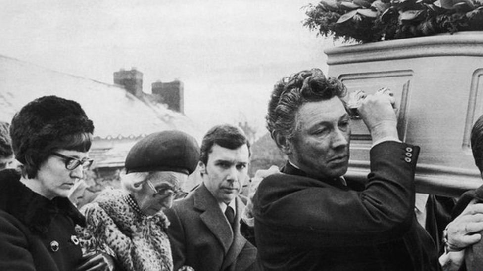 Lesley's brother Ron looking at the camera in a black and white photograph on the day of her funeral.