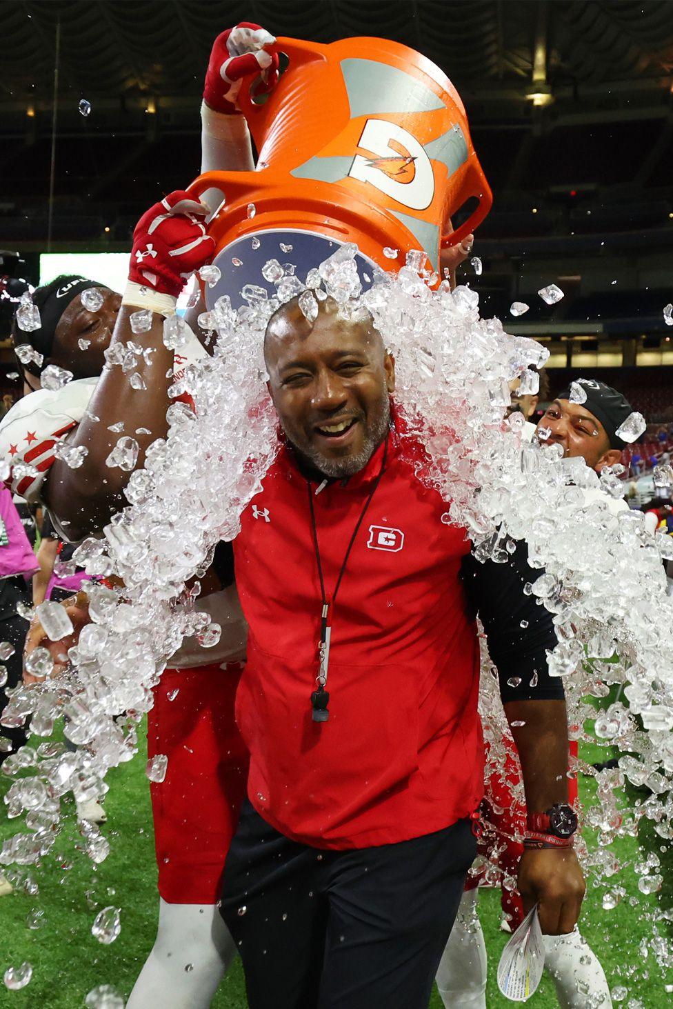 Interim head coach Shannon Harris of the the DC Defenders has ice water dumped on him following the victory against the St. Louis Battlehawks. Photo by Dilip Vishwanat