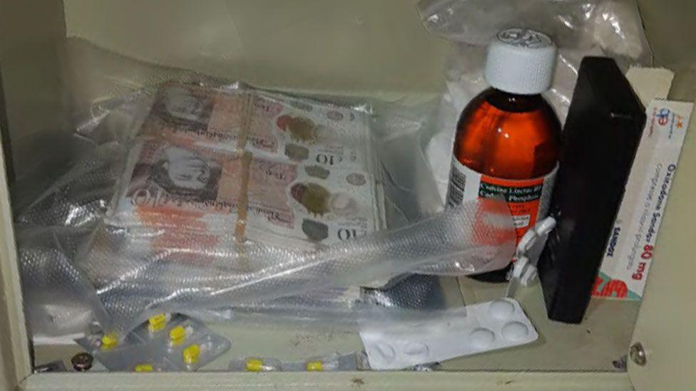 Drug dealer's safe with cash and drugs