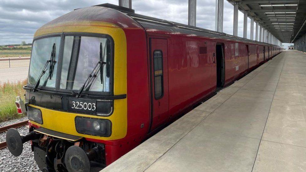 Red Royal Mail train standing at a platform at DIRFT