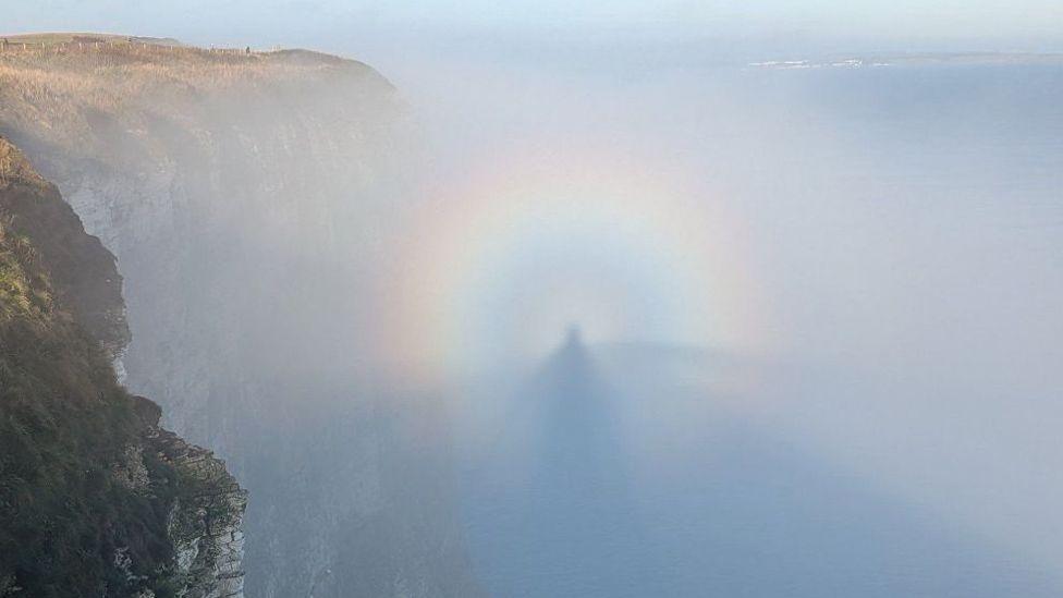 An image of a person's shadow in mist, encased in a rainbow, off Bempton Cliffs in East Yorkshire.