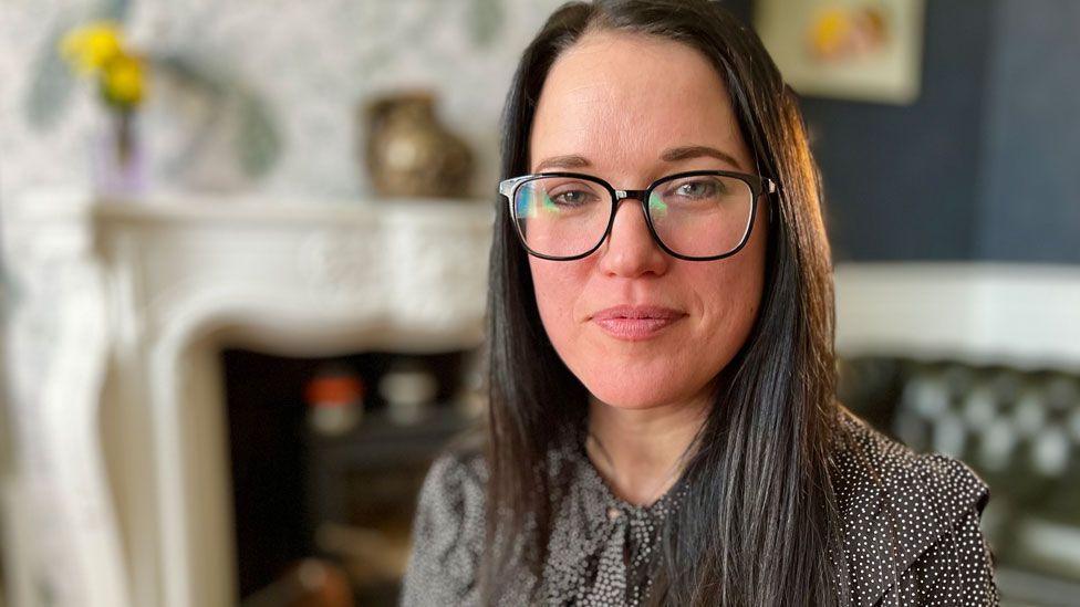 Deborah Manning looking at the camera in a sitting room