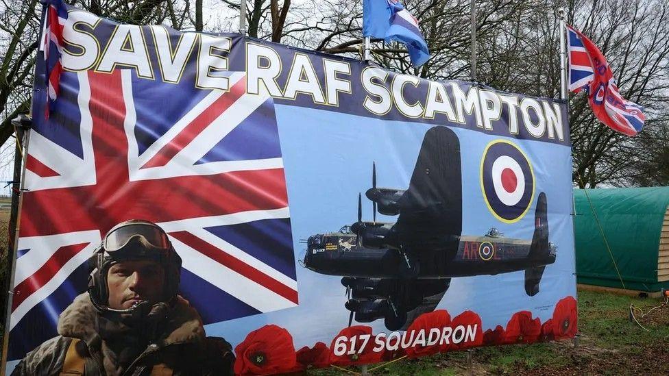 Banner depicting a wartime pilot with goggles and flying jacket with a Lancaster bomber and Union flag in background