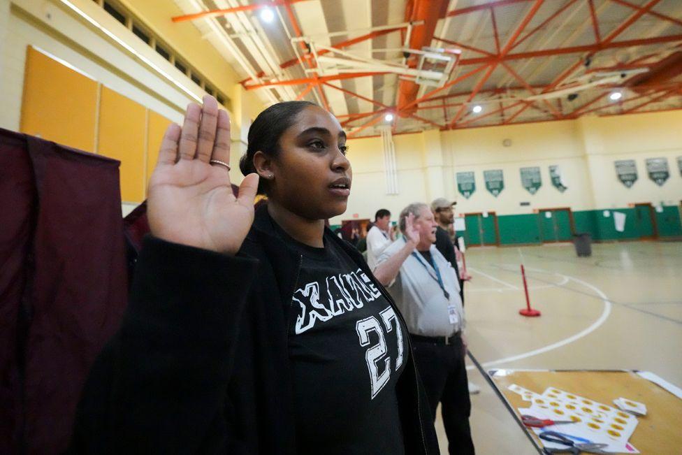 Holyn Robinson raises her right hand and takes her oath along with fellow commissioners just before the opening of the polls, at the Hynes Charter School in New Orleans on Election Day, Tuesday 5 November 2024 