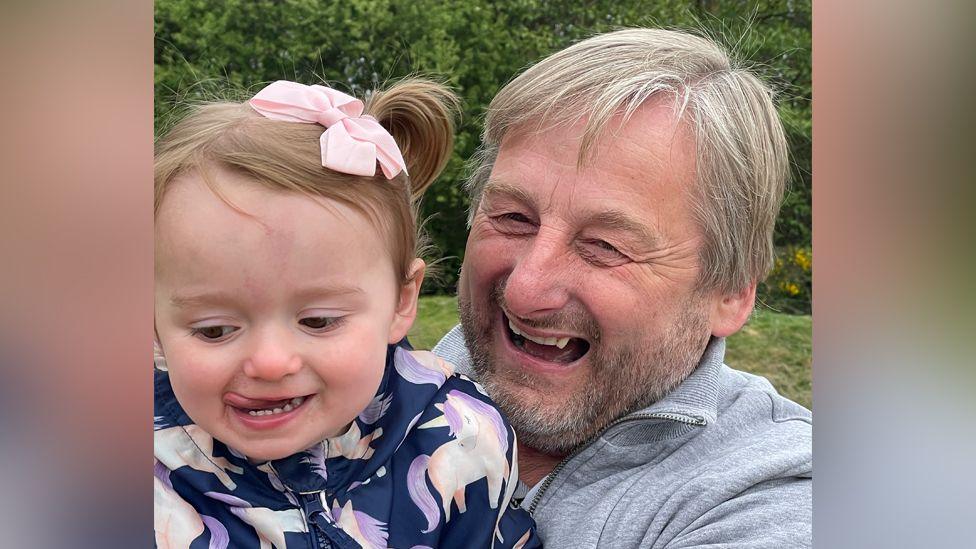 Kevin Holding with his granddaughter