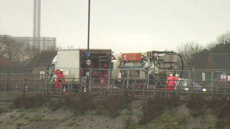 Eastern Road works - workmen in orange clothing working to repair the sewers