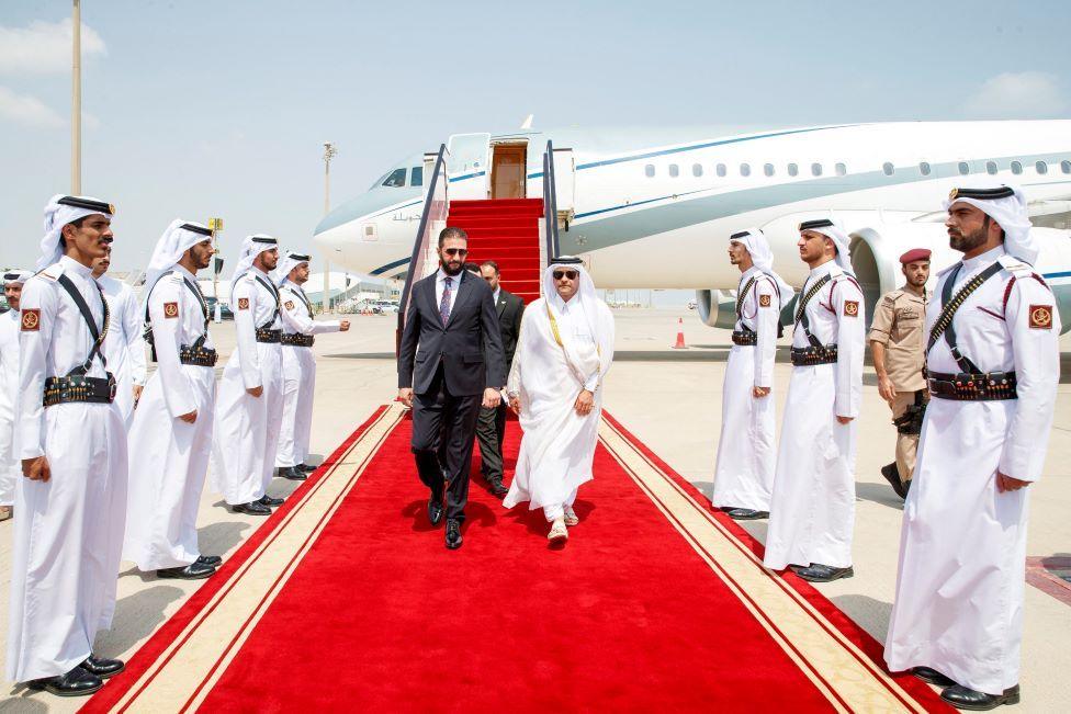 Syrian President Ahmed al-Sharaa walks on red carpet after disembarking a plane in Doha ahead of an emergency Arab-Islamic leaders' summit