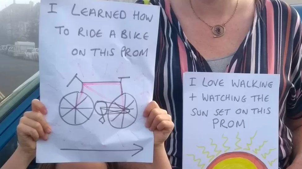 Mother and child holding up protest signs