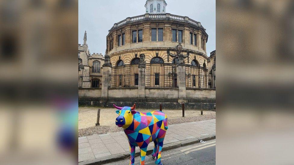 A sculpture of a colourful ox in the city of Oxford