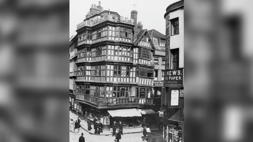A black and white photo of a four storey timber building, the Dutch House, in Bristol