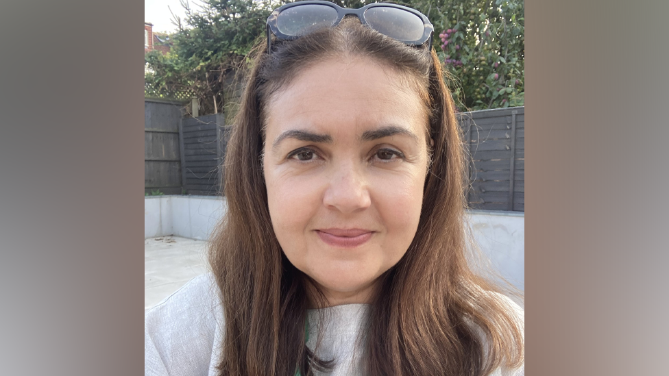 Selfie of Professor Dina Kiwan, wearing a light-coloured top 