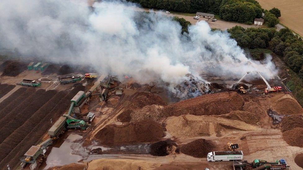 Smoke billowing from bark which is on fire at TMA Bark in Weston Longville, Norfolk.
