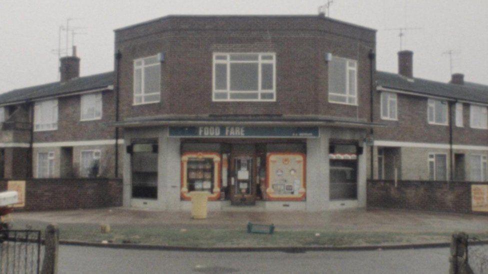 A grainy archive image of the grocery store