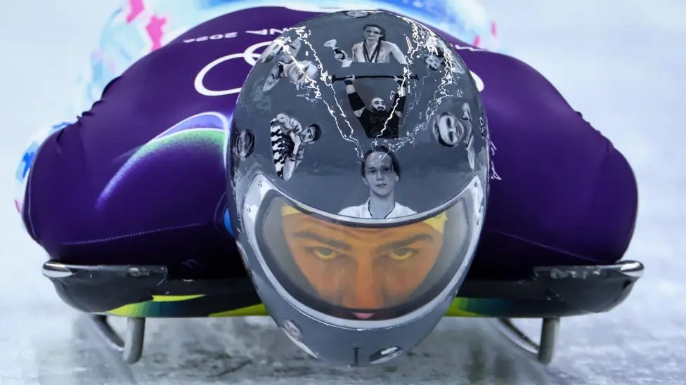 Vladyslav Heraskevych wears helmet with images of those killed in Ukraine war while training for skeleton in Cortina, Italy at Winter Olympics