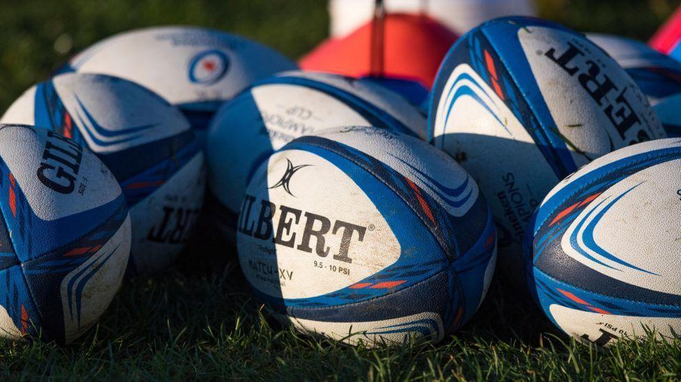 rugby balls on grass