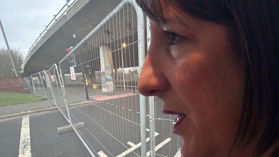 A profile image of Rachel Reeves to the right of a composite image. In the background is the closed Gateshead flyover photographed from below. Temporary fencing blocks the road underneath the flyover.