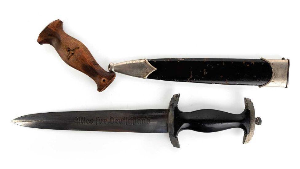 A dress dagger, with a detached wooden handle and sheath, photographed against a white background 