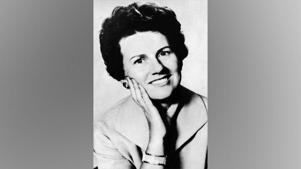 A black and white photo of Muriel McKay, with her hand on her cheek 