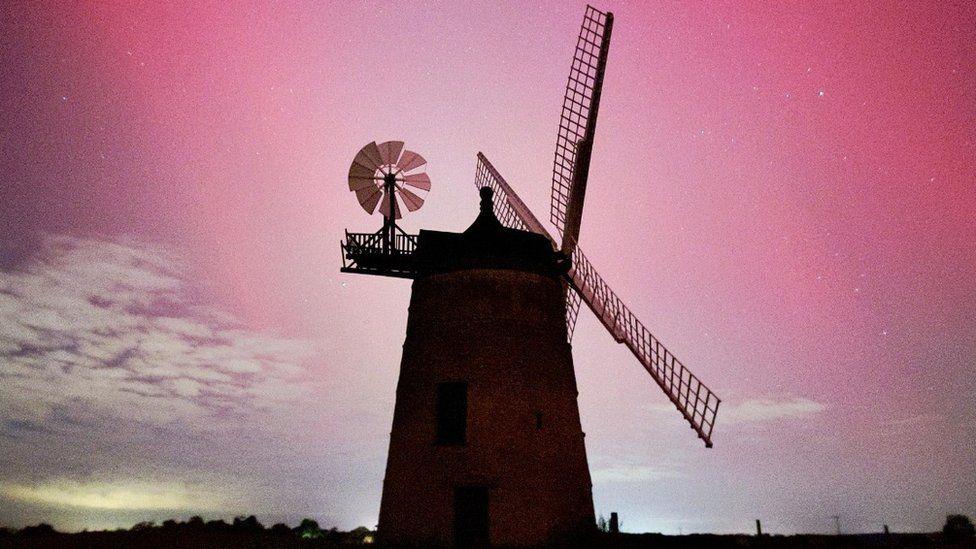 Windmill with pink star dotted sky above