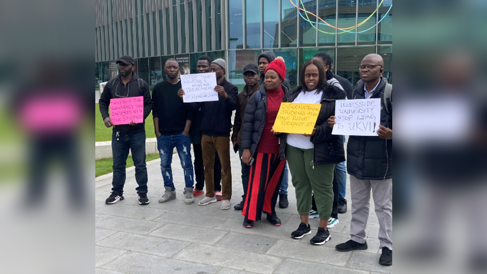 Protestors holding placards outside of Teesside University