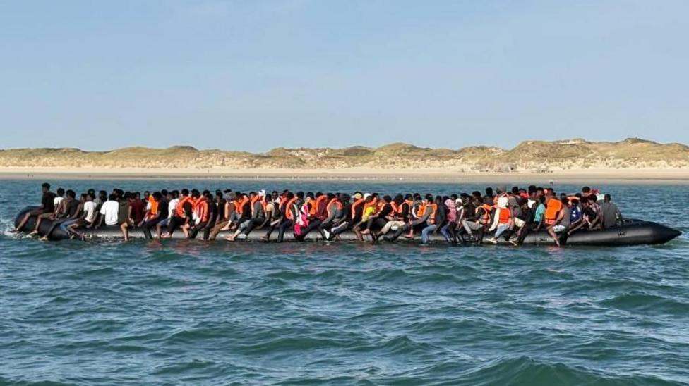 Record 230 people cross Channel in one small boat
