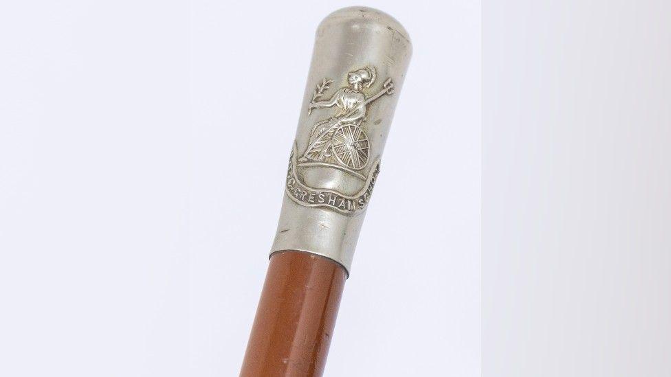 Riding crop engraved with Gresham's School emblem 