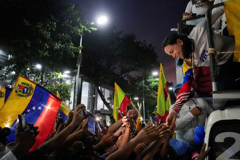 Venezuelan opposition leader Maria Corina Machado greets supporters during a presidential election campaign closing rally in Caracas, Venezuela, July 25, 2024. 