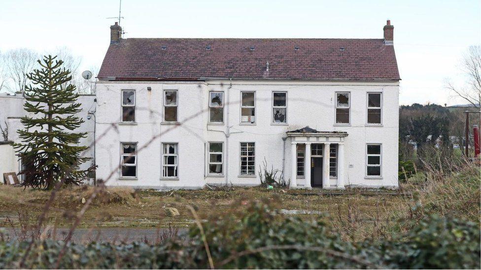 Marianvale is a large two-storey deserted white residential building in a remote setting. It has 14 windows and a front door