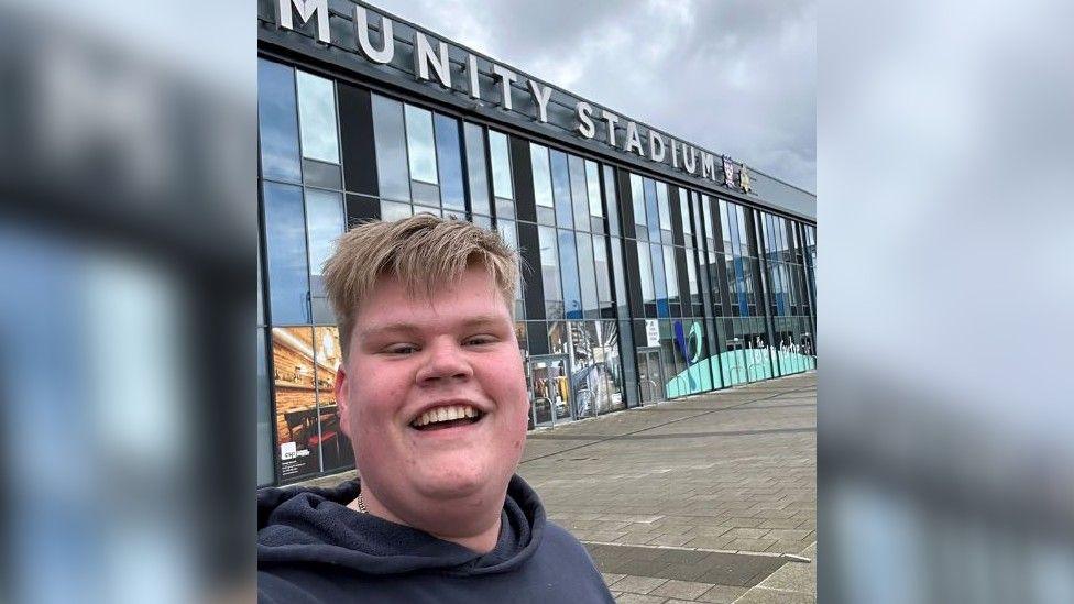 Marcus at a football stadium