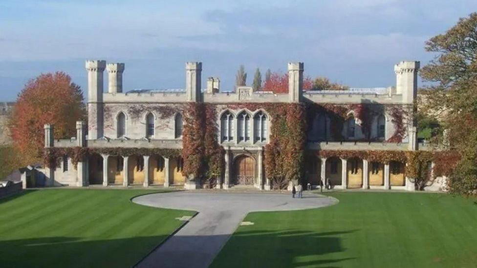 Lincoln Crown Court a two-storey Victorian Gothic building with stone pillars, crenellated roof and six towers with ivy growing up its walls