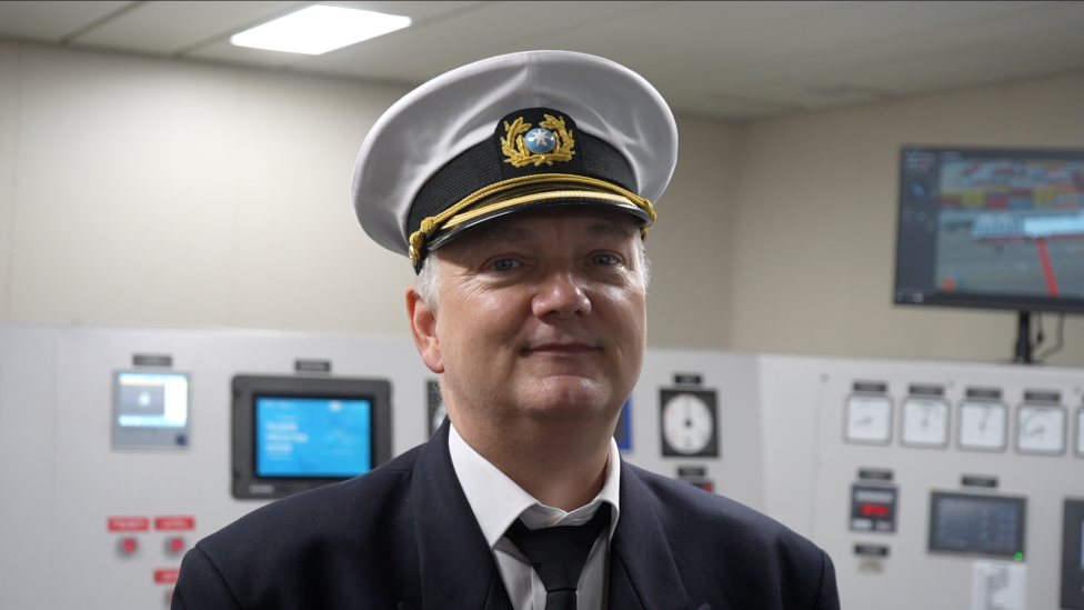 Morten Wehner, chief engineer. He is wearing a dark navy jacket and tie with white shirt. He is also wearing a naval style hat.