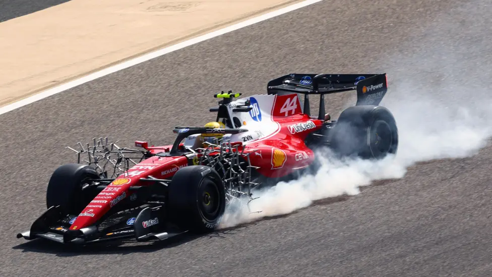 Smoke comes from Lewis Hamilton's Ferrari after he locked the front left tyre in pre-season testing in Bahrain. The car has aerodynamic rakes mounted just behind the front tyres