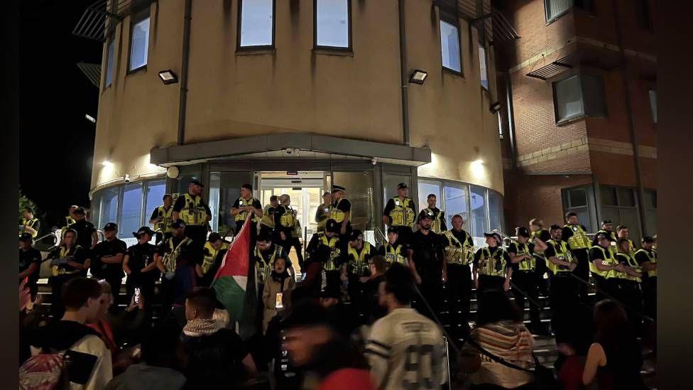 Police and protesters outside Cardiff Bay police station on Monday evening