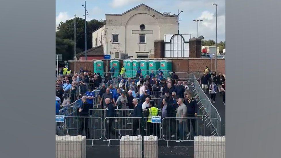Crowds pictured filtering through barriers at Sandhills Station on 9 August.