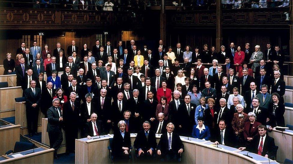 A photograph of the original intake of the Scottish Parliament, 129 MSPs pictured in the previous parliament building at Edinburgh's Assembly Hall.