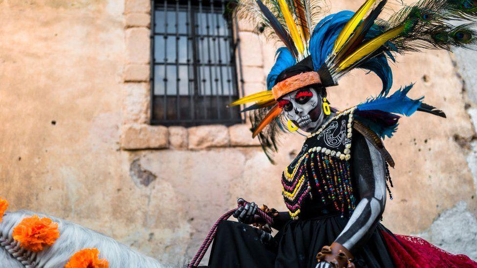 A lady on horseback dressed as La Catrina