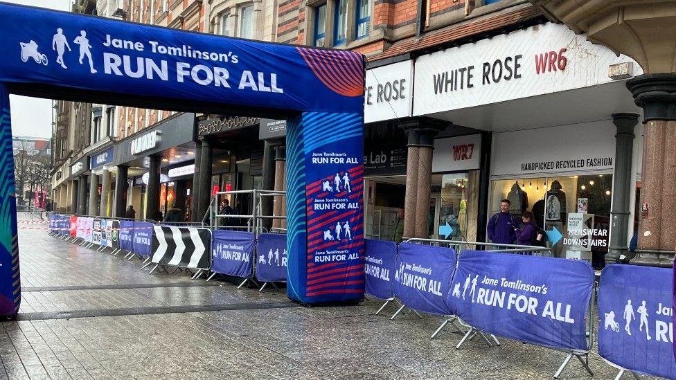 The start line of the 2024 Nottingham 10k, located in the city's Old Market Square, with an arch decorated with Run For All branding.