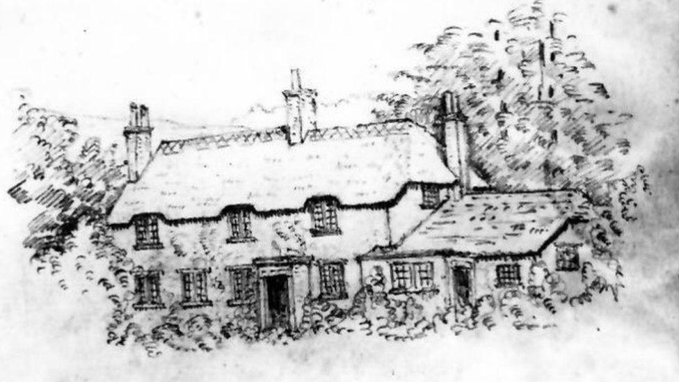 Black and white drawing of cottage and single storey outbuilding attached it has multiple chimneys and stands in a garden with woodland behind.