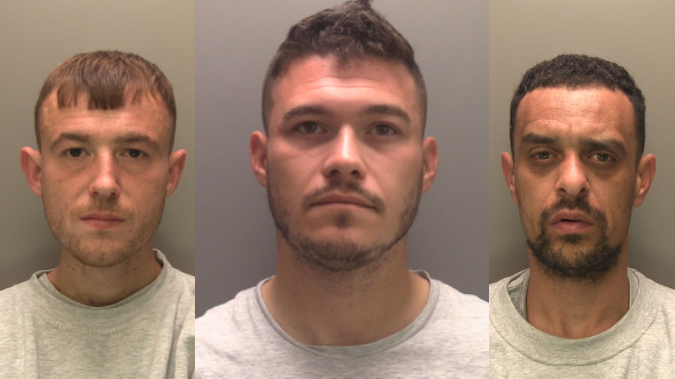 Three mug shots of three men looking at the camera wearing grey sweatshirts. They all have brown hair. The man in the middle and the man on the left both have brown moustaches and beards.