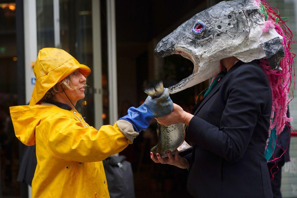 Campaigners from Ocean Rebellion take part in a protest outside the Hilton Hotel, central London, where the Blue Food Innovation Summit is taking place, 21 May 2024.