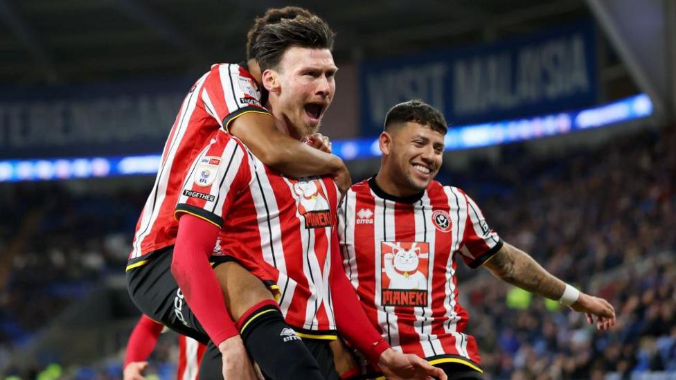 Sheffield United players celebrating scoring at Cardiff City